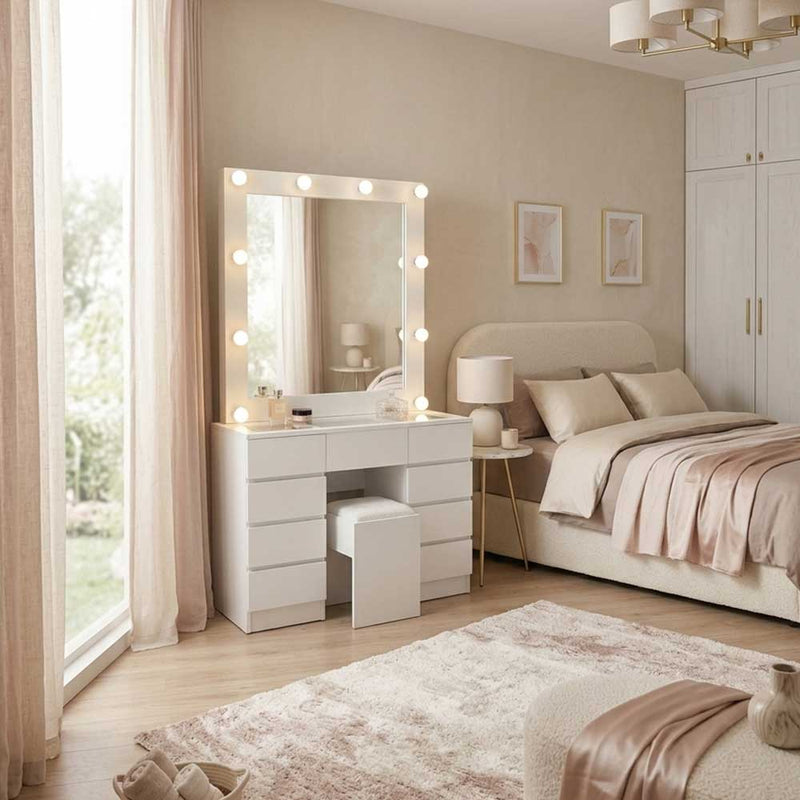 Neatly arranged bedroom with a vanity table, mirror, and bed.
