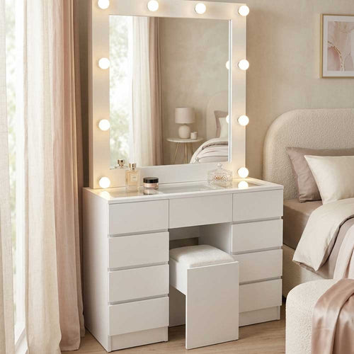 White vanity table with mirror and lights in a bedroom setting