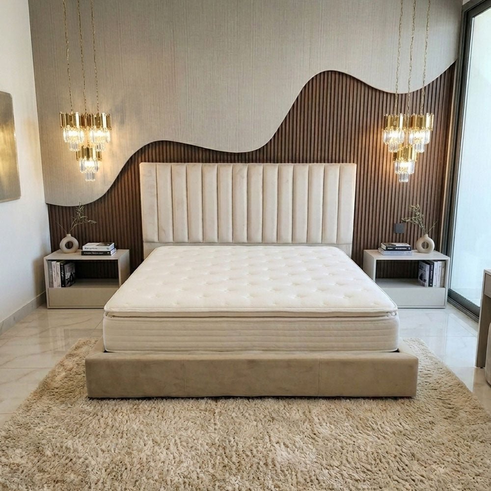 Beige bed with tufted headboard in a modern bedroom setting