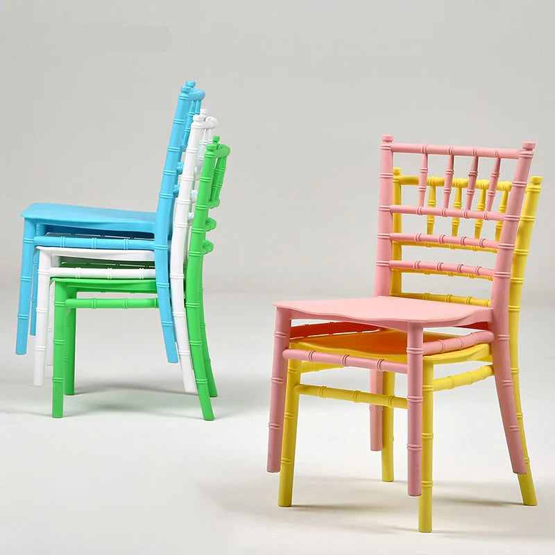 Colorful chairs including pink, yellow, green, and blue on a light gray background
