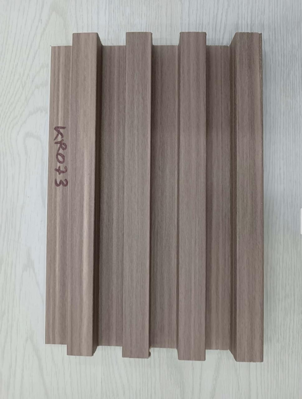 Wooden panel with 'KRO33' branding on a light wooden surface
