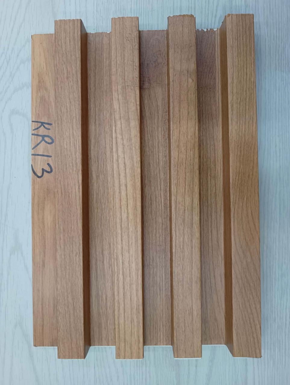 Five wooden planks of different colors arranged vertically on a light blue background.