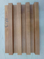 Five wooden planks of different colors arranged vertically on a light blue background.