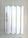 Set of white plastic strips with text on a wooden surface
