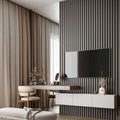 Modern living room with a TV mounted on a textured wall, a white console table, and decorative items.