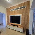 Modern living room with a television mounted on a wooden wall.